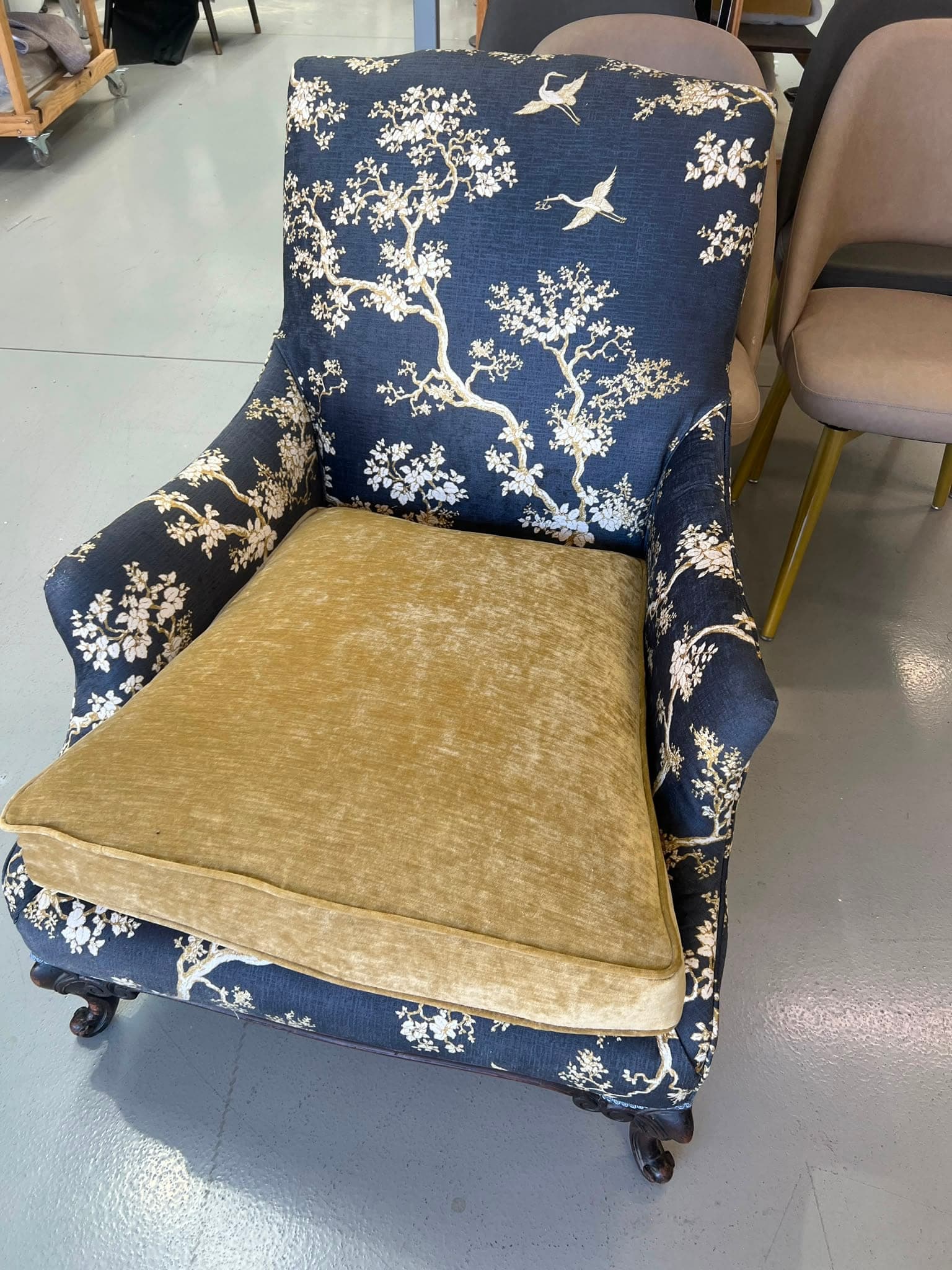 The piped velvet seat cushion and chinoiserie arms, close up