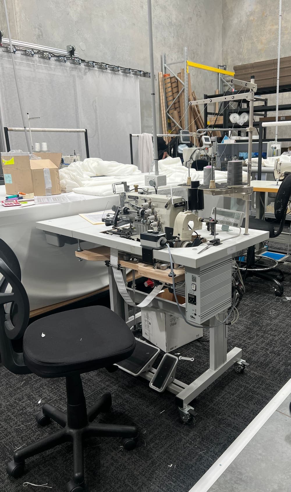 An industrial curtain machine running a long hem