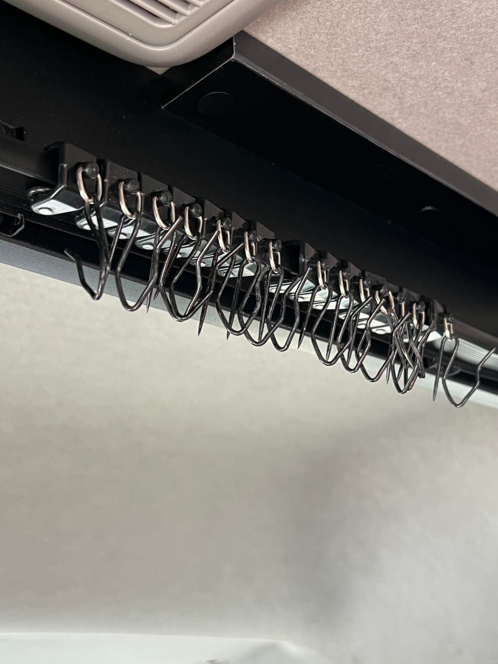 Curtain hooks going onto the track during a fit-out