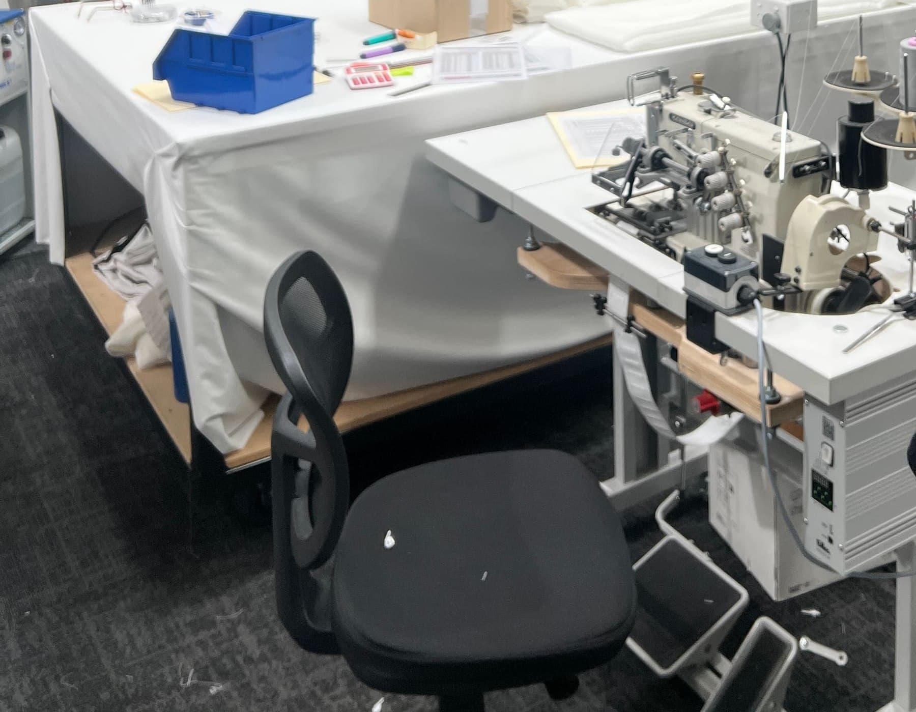 Cutting tables and the coverstitch station on the workroom floor