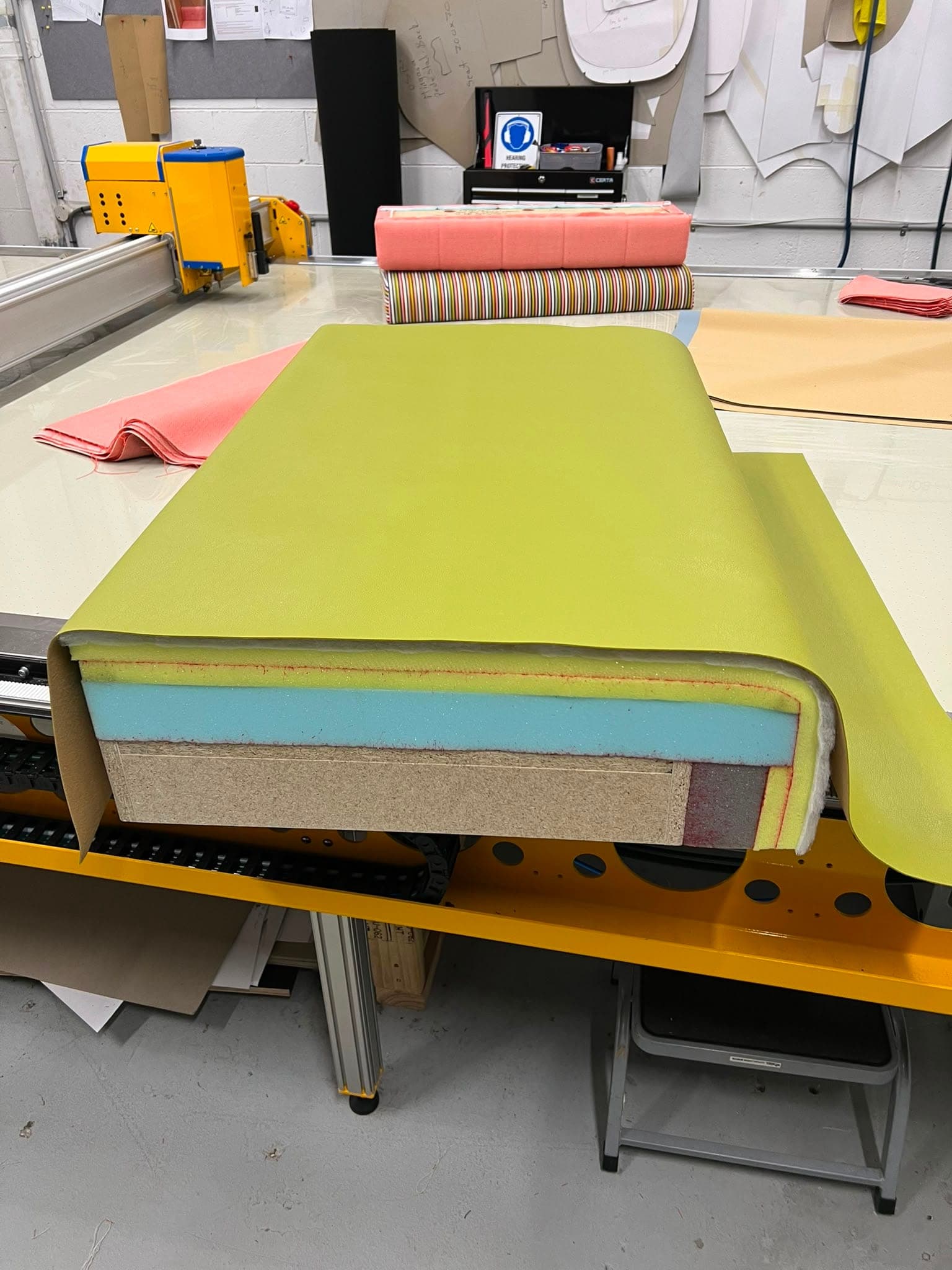 Upholstery vinyl and foam layered on the automated cutting table