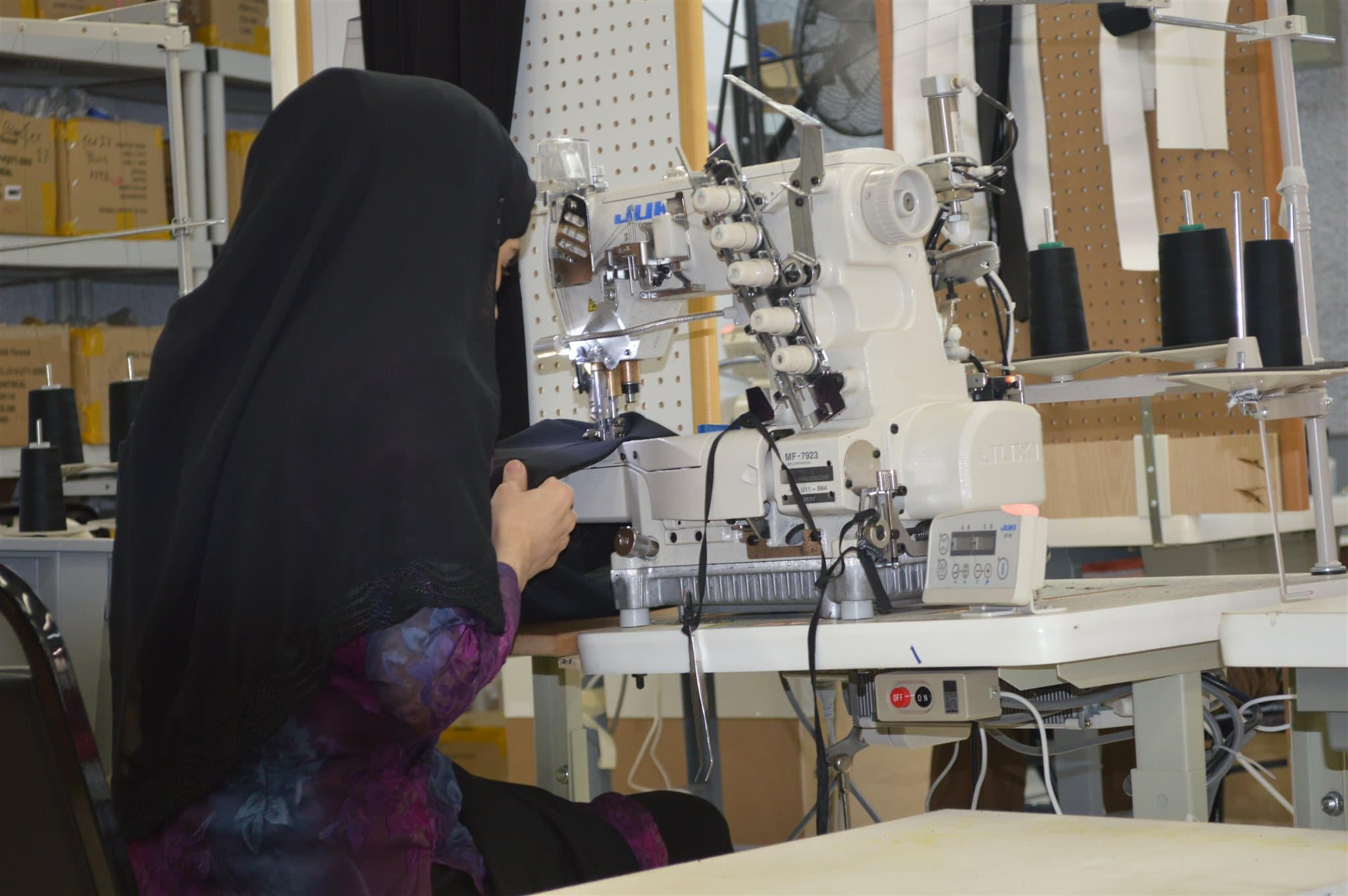 A machinist at the coverstitch station, mid-run