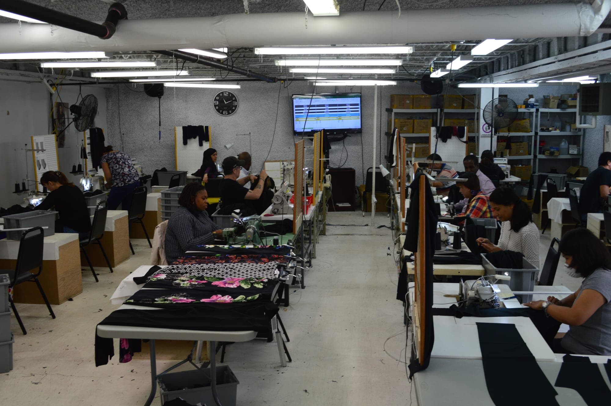 The garment production floor in full swing, machinists at their stations
