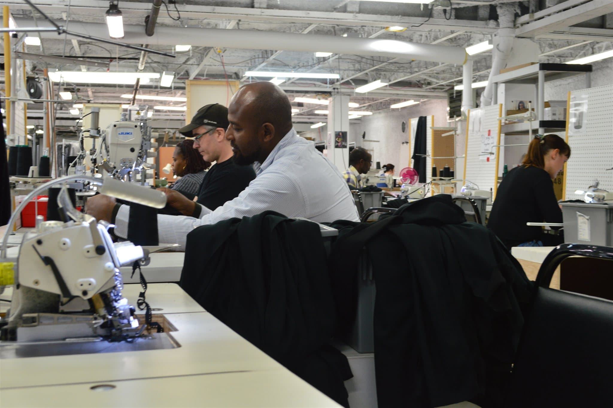 Machinists working side by side through a bulk production run