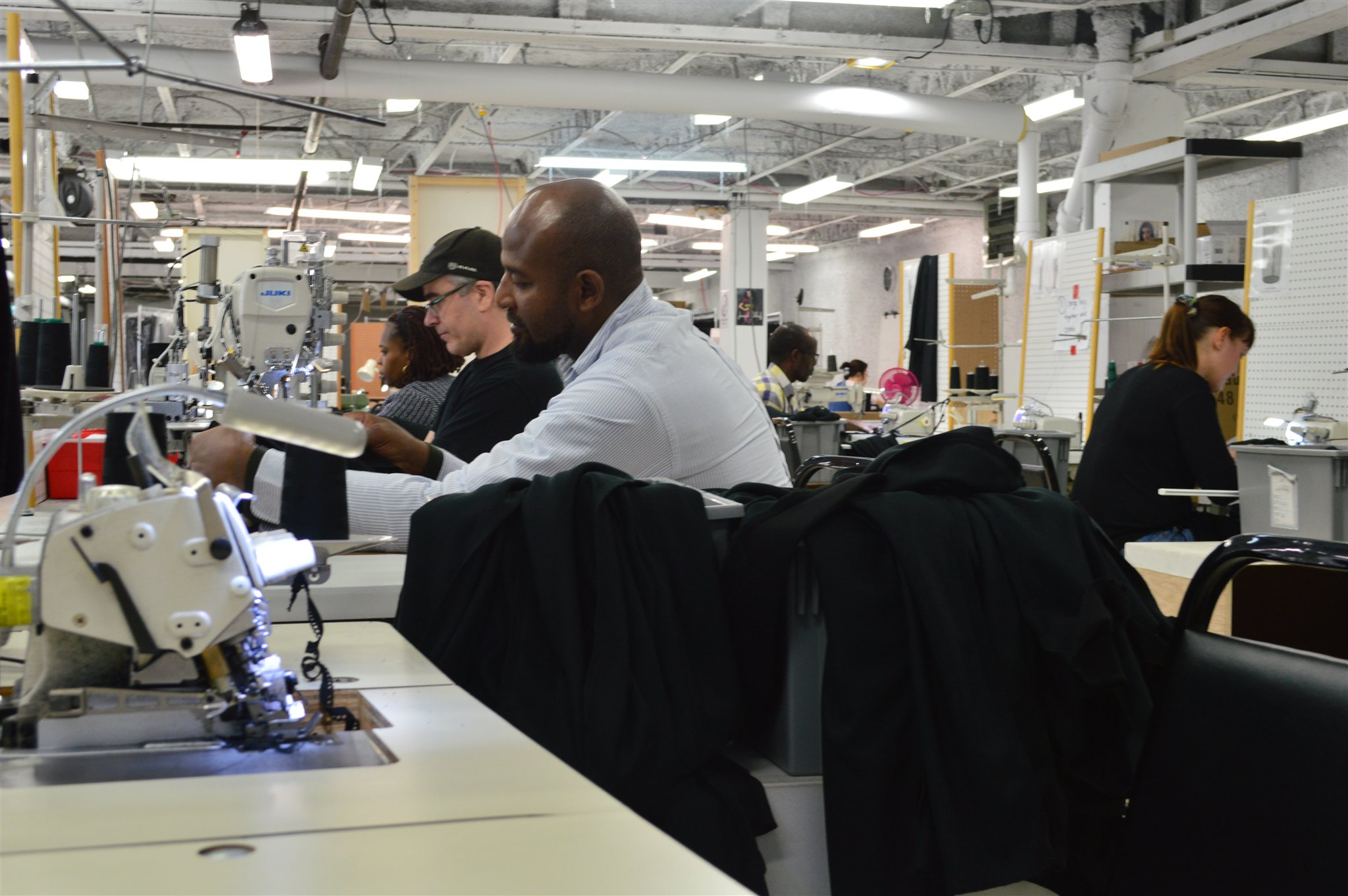 Machinists working side by side through a bulk production run