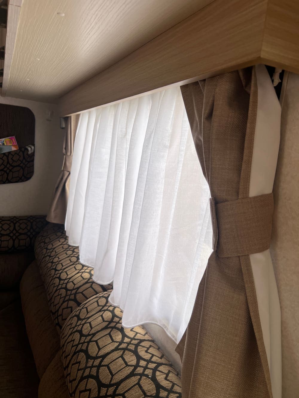A blockout curtain fitted in a campervan window